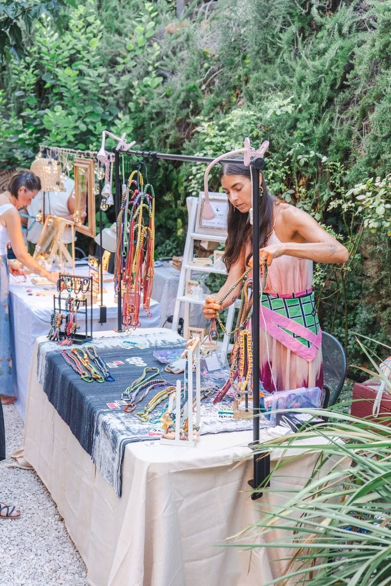 A stand of colourful necklaces and accessories among the plants of Al Giardino Segreto, Gradara
